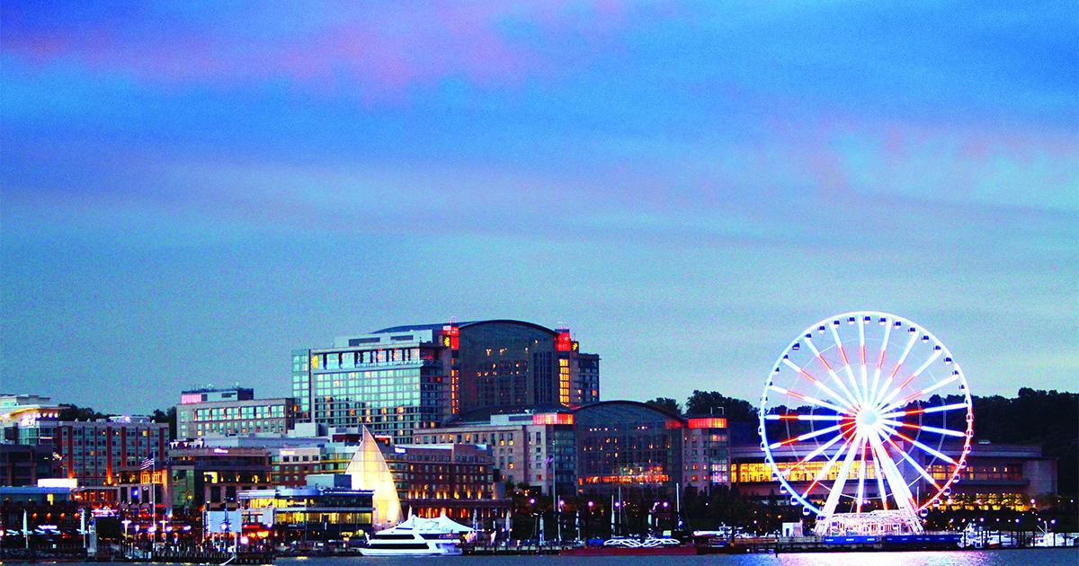 National harbor at sunset view of ferris wheel and gaylord hotel